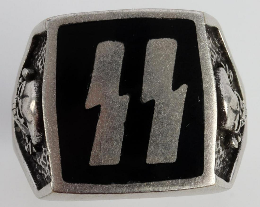 WWII GERMAN THIRD REICH SS OFFICER SKULL RING: German WWII Waffen SS Officers Rune Skull Ring. Measures 3/4 inches inside diameter. The frontshows a pair of Waffen SS runes in the center flanked by a Waffen SS Totenkopf skull and crossbones on eac