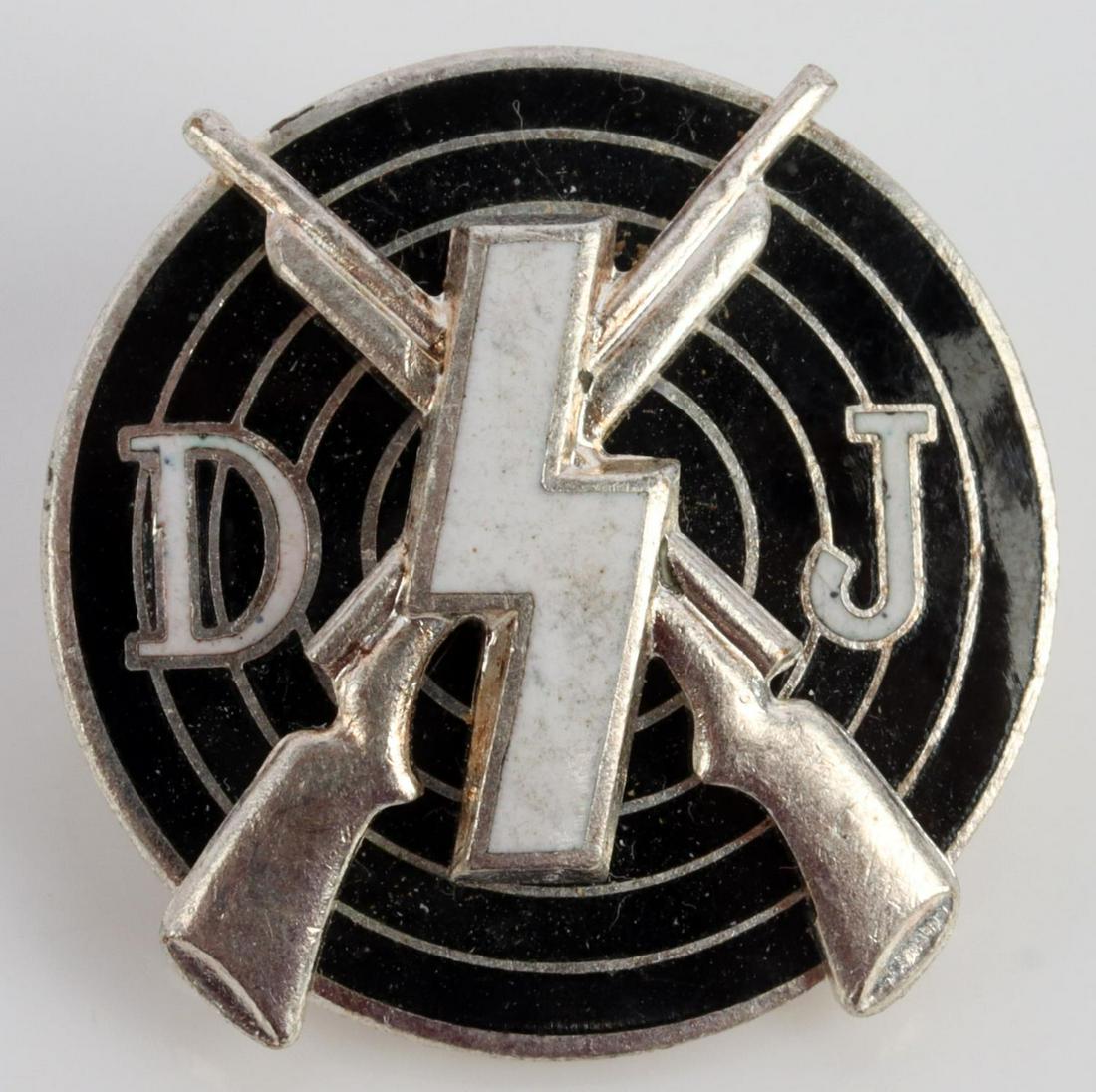 WWII GERMAN THIRD REICH GERMAN YOUTH BADGE: German WWII Deutsches Jugend DJ Runic Marksman Badge. Measures 7/8 inches in diameter. The front reads ‘DJ’. There is a single runic in the center with a pair of crossed rifles and a target in the