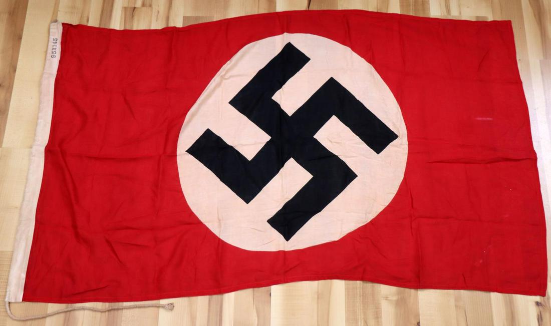 WWII GERMAN THIRD REICH NSDAP BANNER FLAG: German WWII NSDAP Political Swastika Banner Flag. Measures 5 X 3 feet tall. Thefront and the back shows a swastika. Has a beige cotton bunting with rope ties on one end. It ismarked 95X145. Double sid