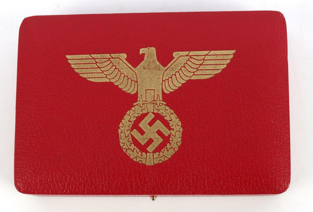 WWII GERMAN REICH NSDAP DECOR PRESENTATION CASE: Measures 5 1/4 inches wide by 3 1/2 inches tall by 1 inches deep. Has a gilded German WWII eagle clutching a swastika in his talons embossed on the upper outside lid. The interior has a black velvet b