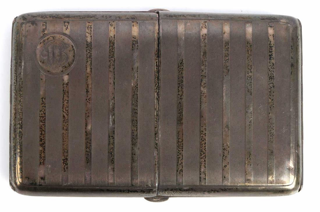 WWI BRITISH NAMED STERLING SILVER CIGARETTE CASE: WWI British sterling silver cigarette cased named to Petty Officer W.T. Burnett. Ribbed exterior design with "WB" monogram on the lid to the top left. British silver marking interior for .925 sterling