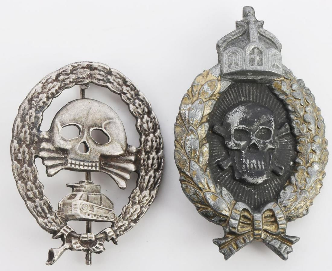 WWI GERMAN PANZER ASSAULT BADGE LOT OF 2: Both totenkopf style pieces surrounded by oak leaf wreath. Very good condition. Measure 2 and 2 3/4 inches. Modern pieces.