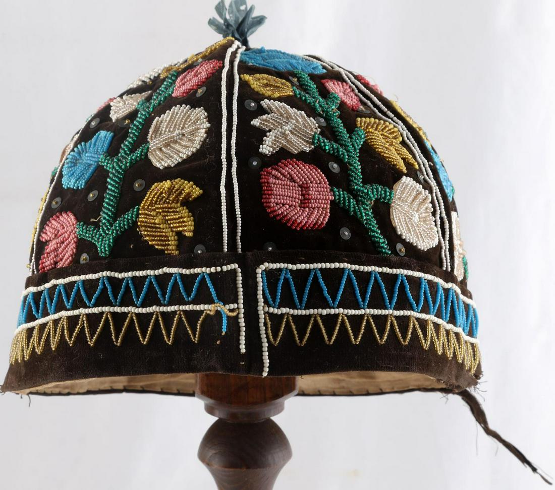 19TH CENTURY SENECA IROQUOIS VELOUR HAT: Intricate flower patterned bead work. Circa 1880s. Measures 7 X 11 inches. Very good condition.