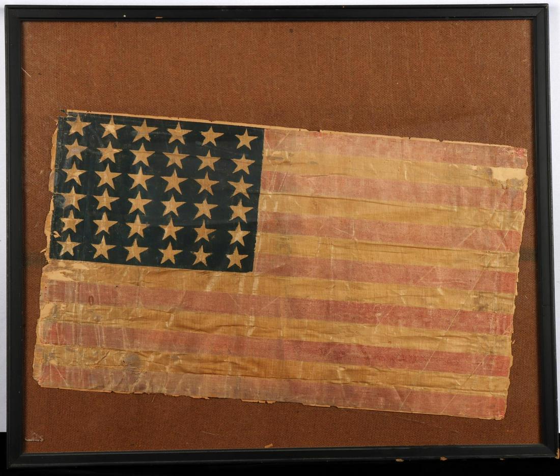 36 STAR FRAMED U.S. CIVIL WAR FLAG: Encased. Flag is made of linen, frail but complete. Measures 21x13 inches and has paper backing. Frame measures 25x21 inches.