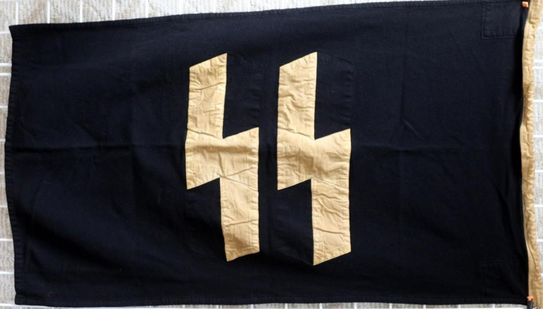WWII GERMAN THIRD REICH SS WOOL FLAG: Th body of this 80x135 centimeter flag is wool and has no fluorescing, the hoist has light fluorescing on the small threads below Lager Fl. stamp, no other part has any. Wool body with linen runes, mo