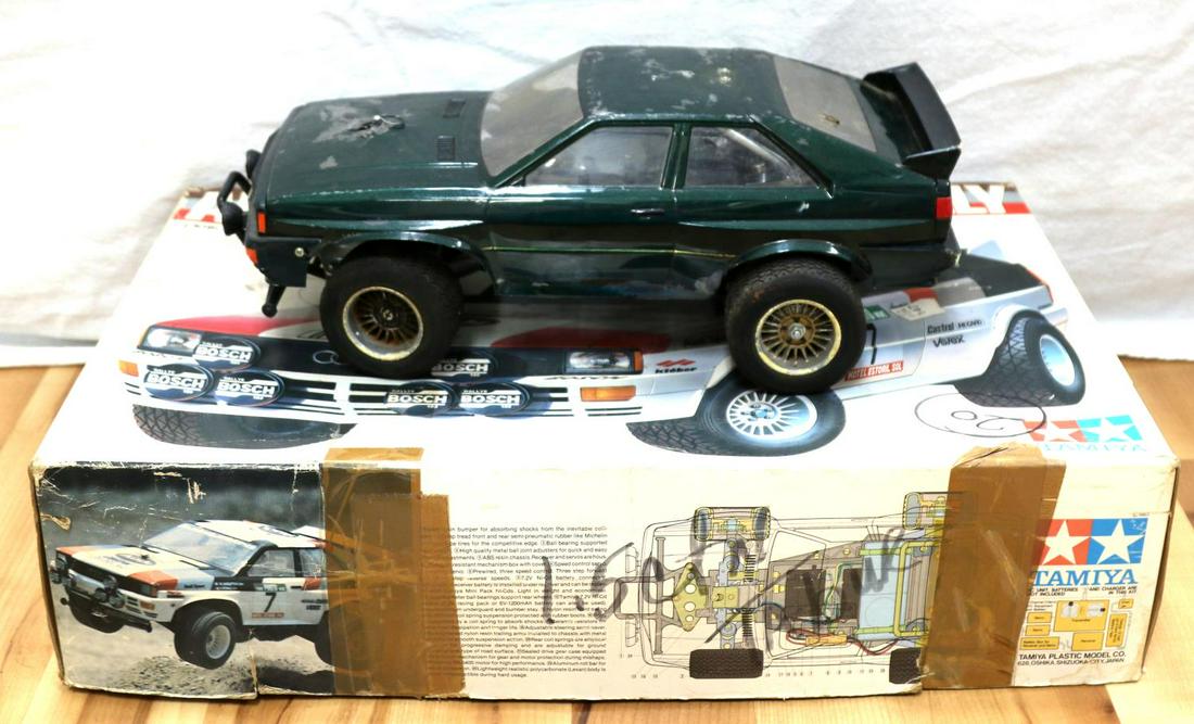 VINTAGE TAMIYA AUDI QUATTRO RALLY 1/10 SCALE CAR: Tamiya Audi Quartto Rally 1/10 scale electric racing car. Green Audi shell with crack in the hood. Overall fair condition for the shell. Tires and motor seem intact. Overall good condition.