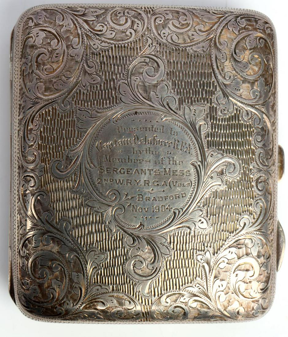 PRE WWI 1904 ROYAL BRITISH NAMED STERLING CIG CASE: Pre-1904 sterling silver cigarette case, dated 1904, presented to Captain Delaforce R.F.A. Exterior features floral design with ribbed spaces. Center on top lid reads "Presented to Captain Delaforce R