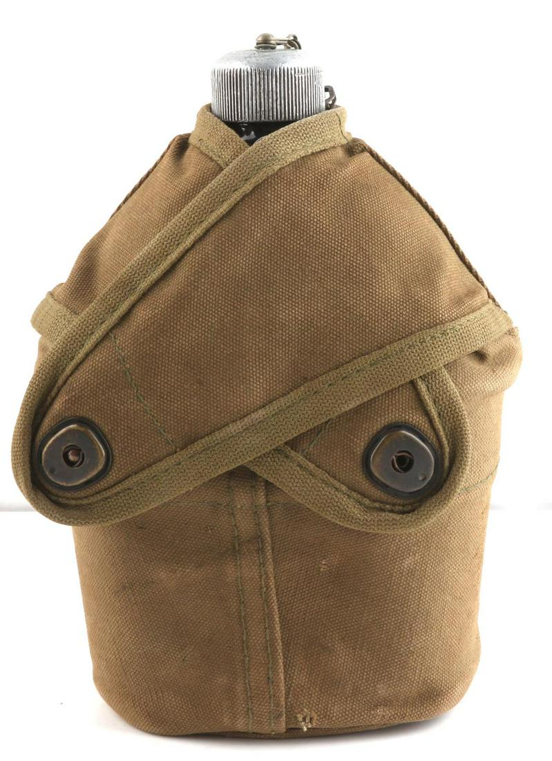 WWII USMC BLACK ENAMEL CANTEEN: Base reads "U.S. Rep 1942." Cup is dated 1945 and named to Tom Braun on cover.