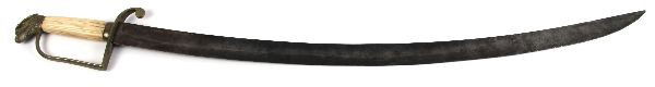 EARLY 19TH CENTURY EAGLE HEAD POMMEL US SABER: Early 19th Century US officers saber. Broad fulllered curved blade measuring just over 28 inches. Brass hilt with eagle head pommel, and ivory grip. Decorative floral engraving on dark patinated blade