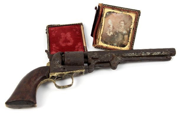 CIVIL WAR ERA COLT 1851 NAVY RELIC & DAGUERREOTYPE: Relic of a Colt 1851 Navy revolver, manufactured in 1860. Percussion nipples and trigger had been removed from the gun, likely so it could be used as a child's toy. Despite re-use as a toy, and relic 