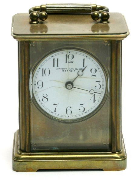 CHELSEA BRASS AND CRYSTAL CASE CARRIAGE CLOCK: Enameled dial marked for "Wright, Kay & Co" "Detroit." Brass case and movement highlighted by beveled crystal panels. Non striking movement is serial number 37522(1905-109). Replacement key is present