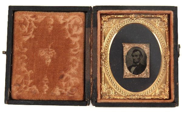 LINCOLN UNION CASE WITH BRADY ENGRAVING COPY: Post Civil War Union Case with Lincoln stamp size Matthew Brady engraving copy, accompanied by a very old typed description in brief, "Copy (hence Reversed) of original taken by Brady at Washington, F
