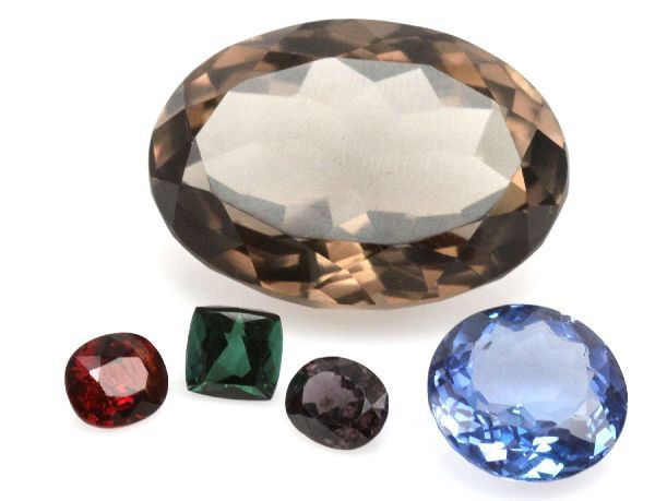 MIXED LOT TOURMALINE QUARTZ TOPAZ & SPINEL 118 CTW: Mixed lot of green tourmaline (2.70 cts), smoky quartz (34.6 by 23.7 by 17.3 millimeters), Swiss Blue topaz (18.5 by 17.5 by 10.8 millimeters), and sparkling spinel. Weight: 118.46 ctw Condition: Over