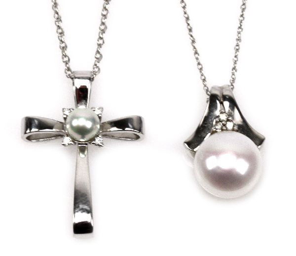 LOT OF LADIES PEARL AND 14K GOLD JEWELRY: Ladies lot of 14K gold and pearl jewelry. Features one Sea Magic of Mikimoto pearl cross pendant and chain in original box ( 3.8 g), one round drop pearl with accent diamonds pendant and chain (2.9 g)