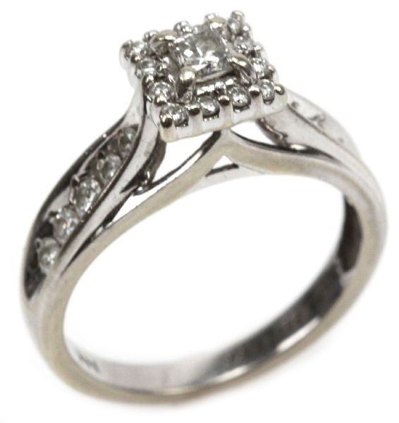 LADIES 14K WHITE GOLD DIAMOND RING: Ladies 14K white gold diamond ring. Features large princess cut center stone approx. 0.24 cts., surrounded by 12 diamonds approx. 0.03 cts. with 10 channel set diamonds along the band, ranging from ap