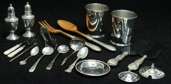 LARGE LOT OF MIXED STERLING SILVER PIECES: Two mint julep cups, wooden salad tongs with sterling handles, tongs, salt and pepper shakers, three small spoons, one ladle, two cake servers, two lids, one coaster, silver decorative spoon, and thre