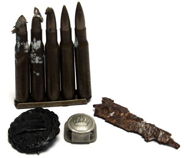 WWI IMPERIAL GERMAN SCHRAPNEL WOUND BADGE: Interesting grouping of WWI items. Lot includes obviously wound souvenirs, Schrapnel, damaged Mauser ammo, cap button and wound badge.