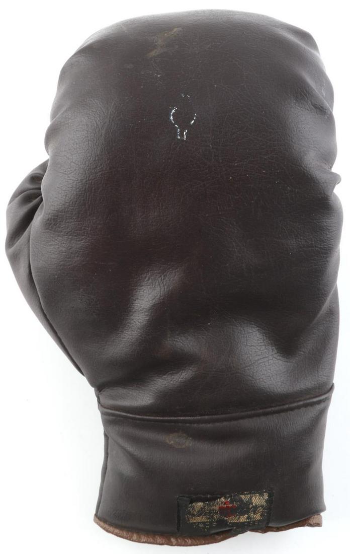 1940S CANADIAN BOXER TOMMY BURNS SIGNED GLOVE: Boxing glove autographed by Canadian boxer Tommy Burns. Only Canadian born boxer to hold the World Heavyweight Boxing Champion. Brown leather glove signed in black sharpie. The signature can easily be