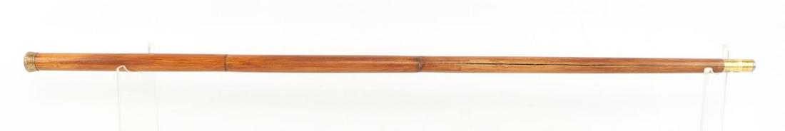 ANTIQUE SYSTEM WALKING STICK CANE FISHING POLE: Measures 34 1/4 inches. Gold fill cap is removable and converts to a fishing pole. In very good original condition.