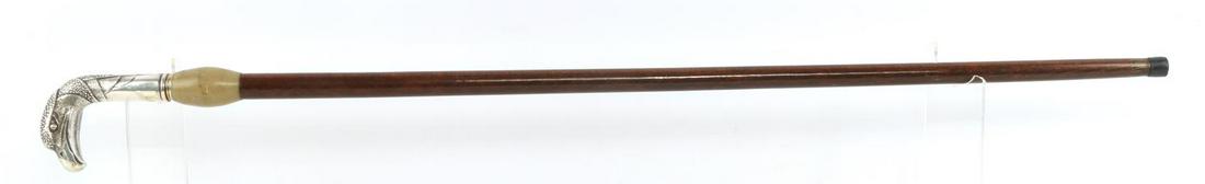 ANTIQUE FALCON HEAD SWORD CANE WALKING STICK: Silver wash falcon head grip, marble sword throat, with rubber ferrule tip. Overall cane measures 35 inches, trefoil sword blade and grip measure 30 inches, and is in very good original condition.