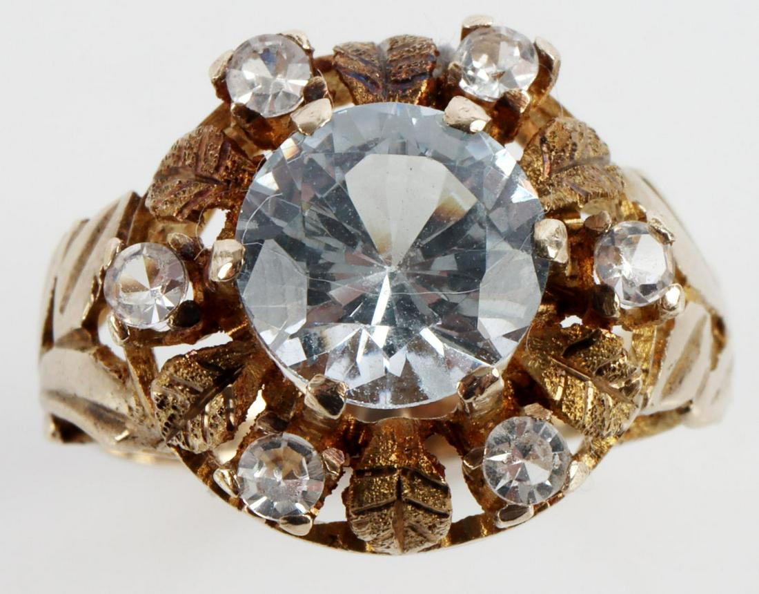 14K YELLOW GOLD BLUE WHITE TOPAZ ANTIQUE RING: Stamped "14K" inside shank. Center topaz has faint blue tint and measures 8 millimeters. Accenting white topaz measures 2.26 millimeters. Size 6.75 and has a total weight of 3.5 grams. This lot has a