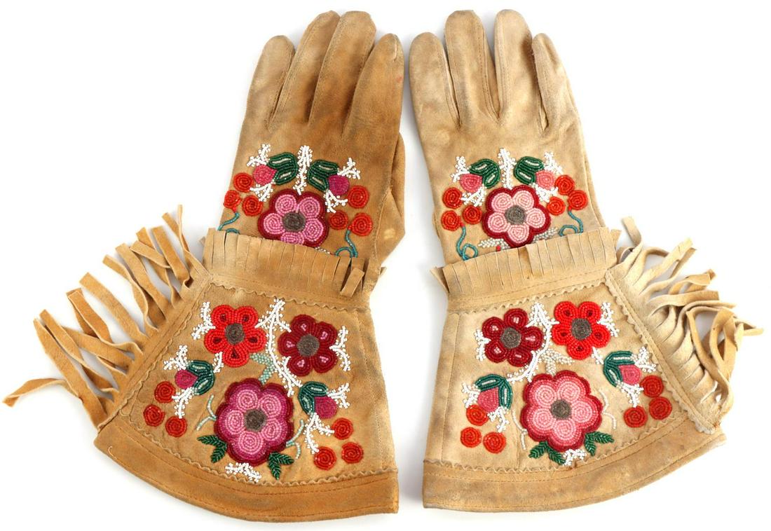 CHIPPEWA INDIAN BEADED BUCKSKIN GAUNTLET GLOVES: Chippewa Ojibwa Native American brain tanned buckskin gloves adorned in glass bead floral designs and fringe. Circa late 19th to early 20th century. Light to medium use wear and soft to the touch. Bea
