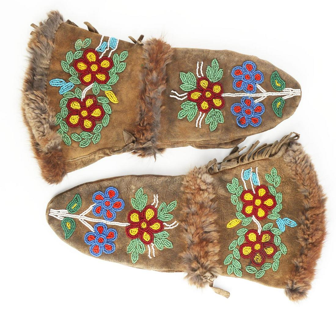 CHIPPEWA INDIAN BEADED BUCKSKIN GAUNTLET GLOVES: Chippewa Ojibwa Native American brain tanned buckskin gloves adorned in glass bead floral designs and and fur. Circa late 19th century. Light to medium use wear, heavier use wear noted to palms. Beadi