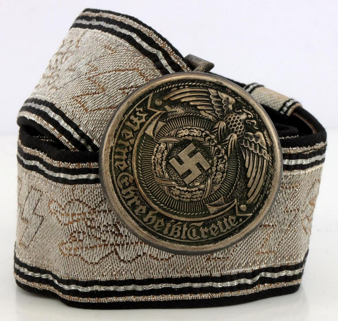 WWII GERMAN SS OFFICER BROCADE BELT & BUCKLE: Non-fluorescing. Alternating SS runes and oak leaves. Inlaid silver bullion. Aluminum buckle marked RZM SS 93/36. Belt measures 39 inches long. Very good condition.