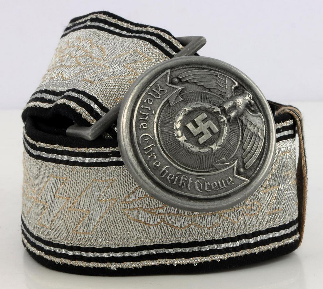 WWII GERMAN SS OFFICER BROCADE BELT & BUCKLE: WWII German SS Officer brocade belt & buckle. Non-fluorescing. Alternating SS runes and oak leaves. Inlaid silver bullion. Zinc buckle marked RZM SS 36/39 OLC double stamped. Belt measures 41 inches l