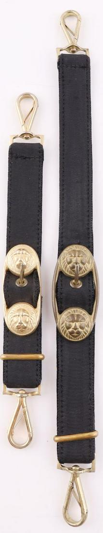 WWII GERMAN KRIEGSMARINE DAGGER HANGERS: Brass lions head clasps with black fabric hangers and brass clasps. Measure 10 and 15 inches. Very good condition. Unauthenticated, sold as is.