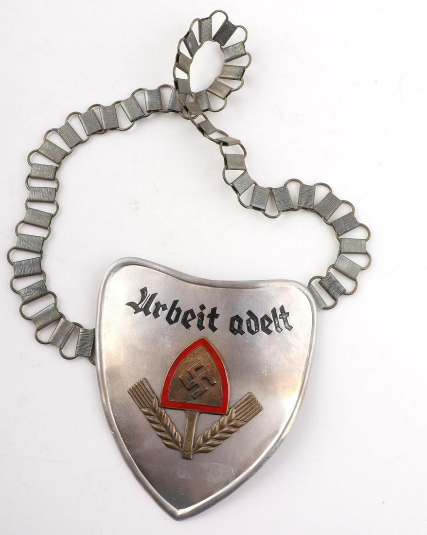 WWII NAZI GERMAN LABOUR SERVICE OFFICERS GORGET: A WWII Nazi German Third Reich RAD Labour Service officers gorget. With a cloth backing and two hooks to the back. Marking "A" on back side of gorget. Dimensions: Gorget: 5 x 4 3/4 in. Chain L: 25 in.