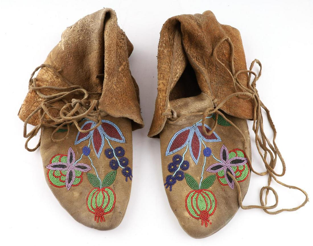LATE 1800'S CHIPPEWA BEADED DEERSKIN MOCCASINS: Delicate brain tanned Chippewa moccasins adorned with glass bead floral designs. Very soft with evidence of use wear. Length of 10 inches.