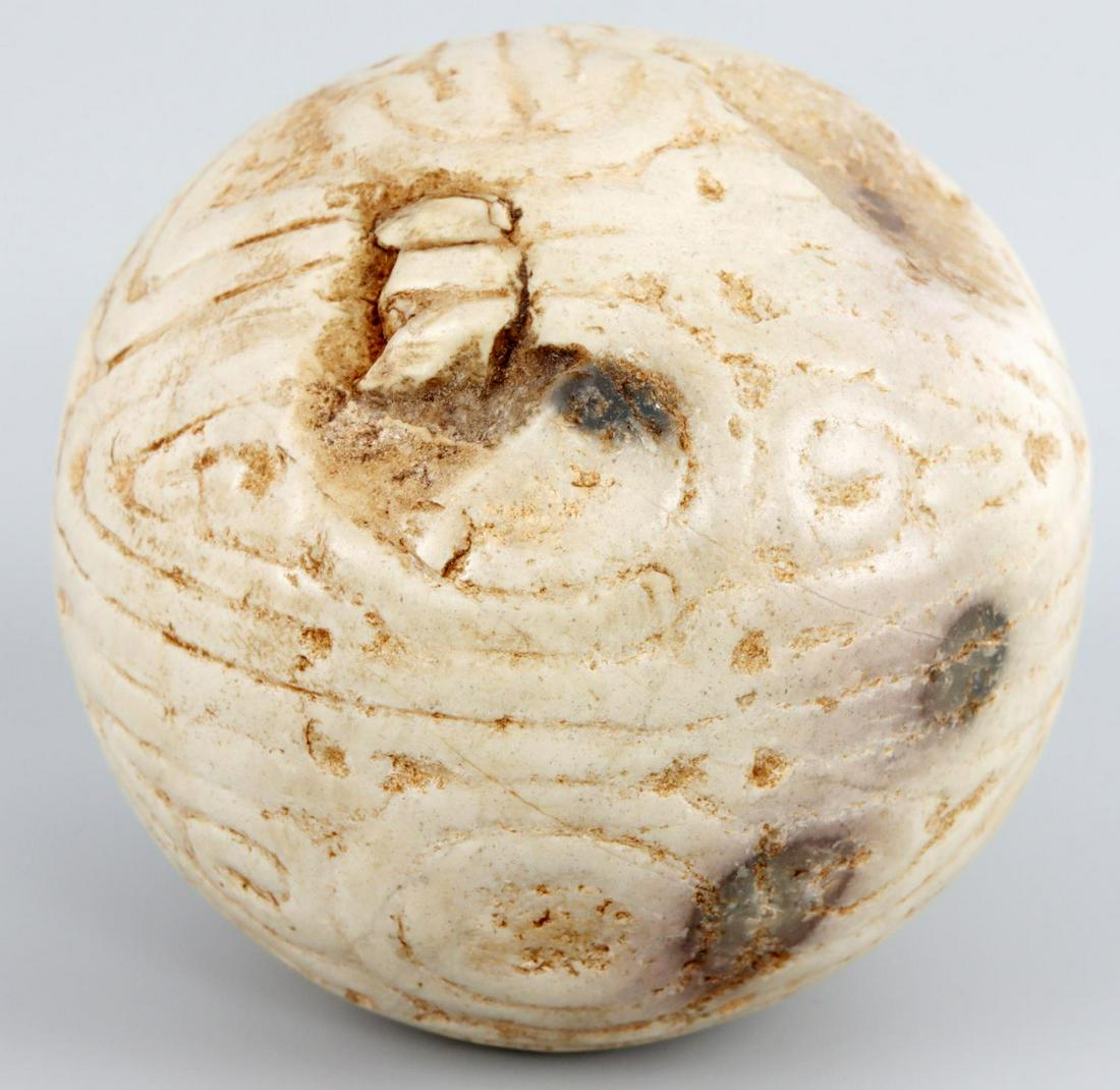 TAINO PRECOLUMBIAN CEREMONIAL BALL BIRD PATTERN: Taino. PreColumbian. 3 inch diameter. Ceremonial ball with an interesting design of double bird heads emerging from circles. One side of the ball has a oval indention with bird beaks on each side. The