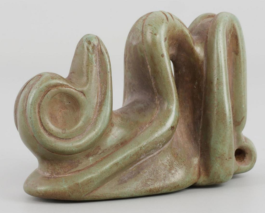 TAINO HUMAN TO IGUANA TRASFORMATION CARVING: Taino. PreColumbian. Human to iguana transformation. Beautifully carved in high dimensional relief. On the base are a group of swirls and curvilinear designs. At the base of the designs is the face of