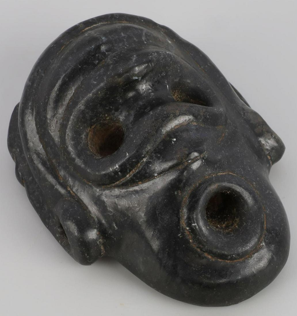 TAINO HOWLER MONKEY CARVED HEAD: Taino. PreColumbian. Outstanding Howler monkey head. A second head is clearly visible when inverted. The eyes are drilled to connect to one another and the mouth. The ear spools have suspension holes 