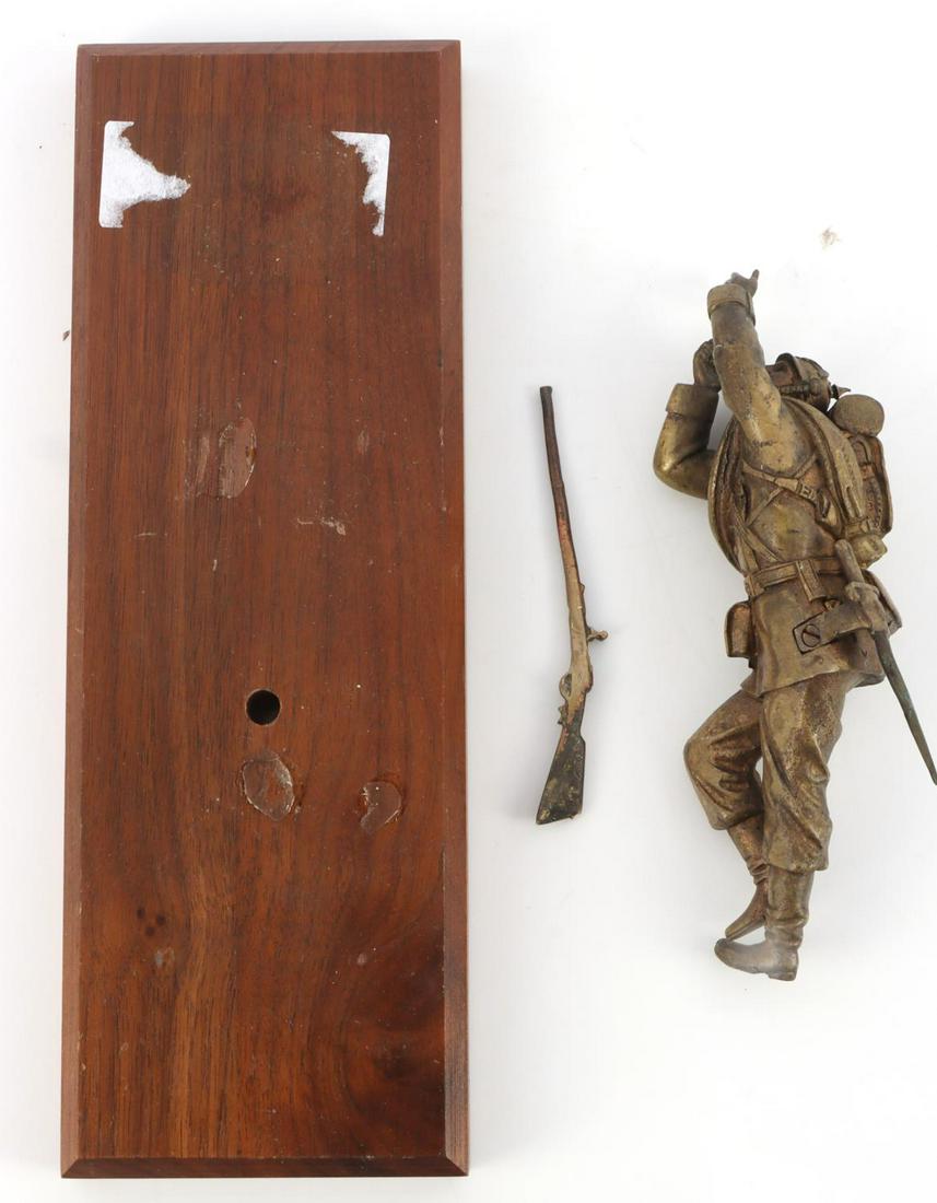 BRONZE WWI IMPERIAL GERMAN SOLDIER WITH RIFLE: Bronze WWI Imperial German Soldier in the prone position with rifle included with a wooden base. Soldier in uniform with pickelhaub, bayonet, backpack, and detachable rifle. Soldier is missing the mou
