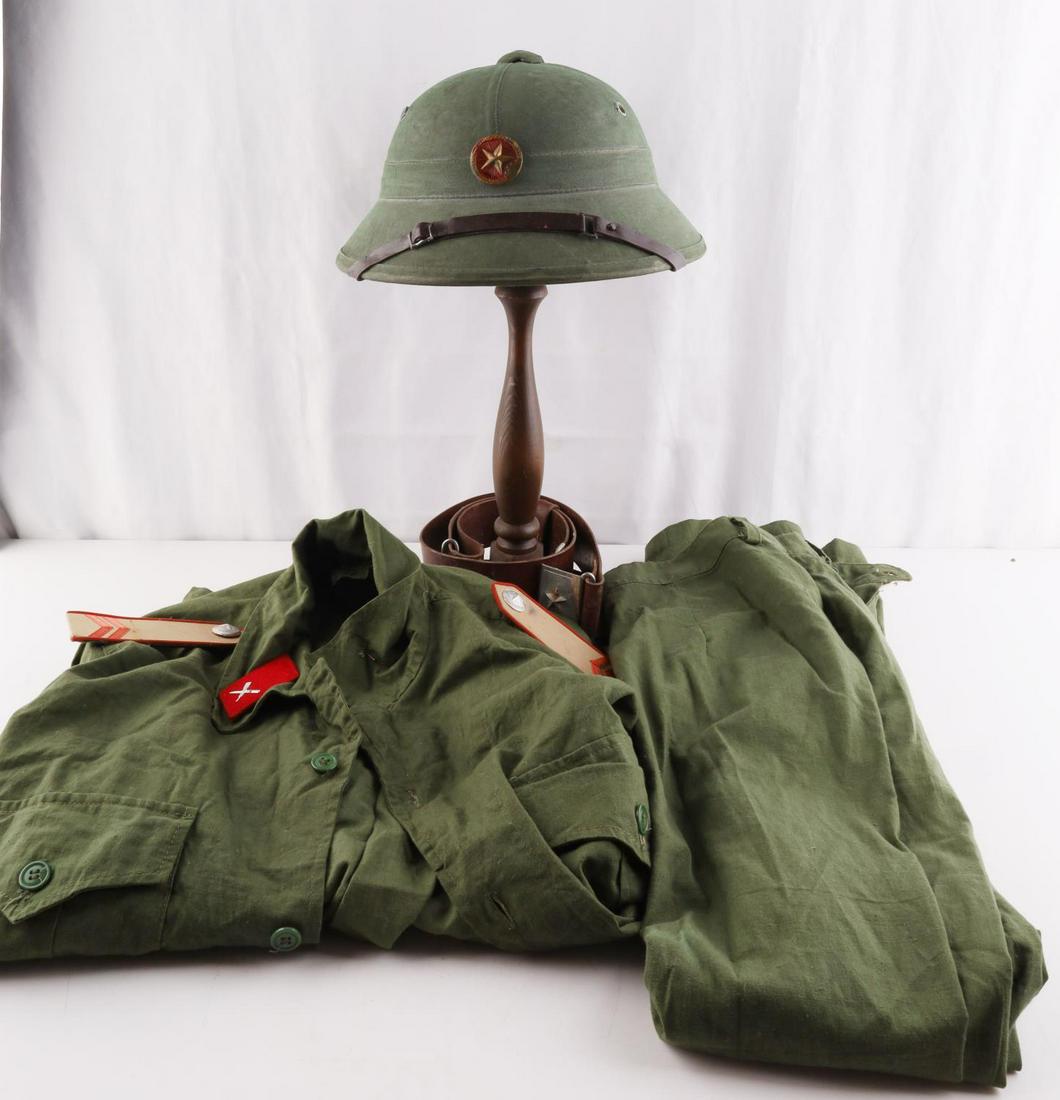 NVA VIET CONG UNIFORM PITH TUNIC PANTS AND BELT: Very good condition with usage wear. Pith helmet has liner and sticker on interior. Tunic features collar tabs and shoulder boards. Medium sized.