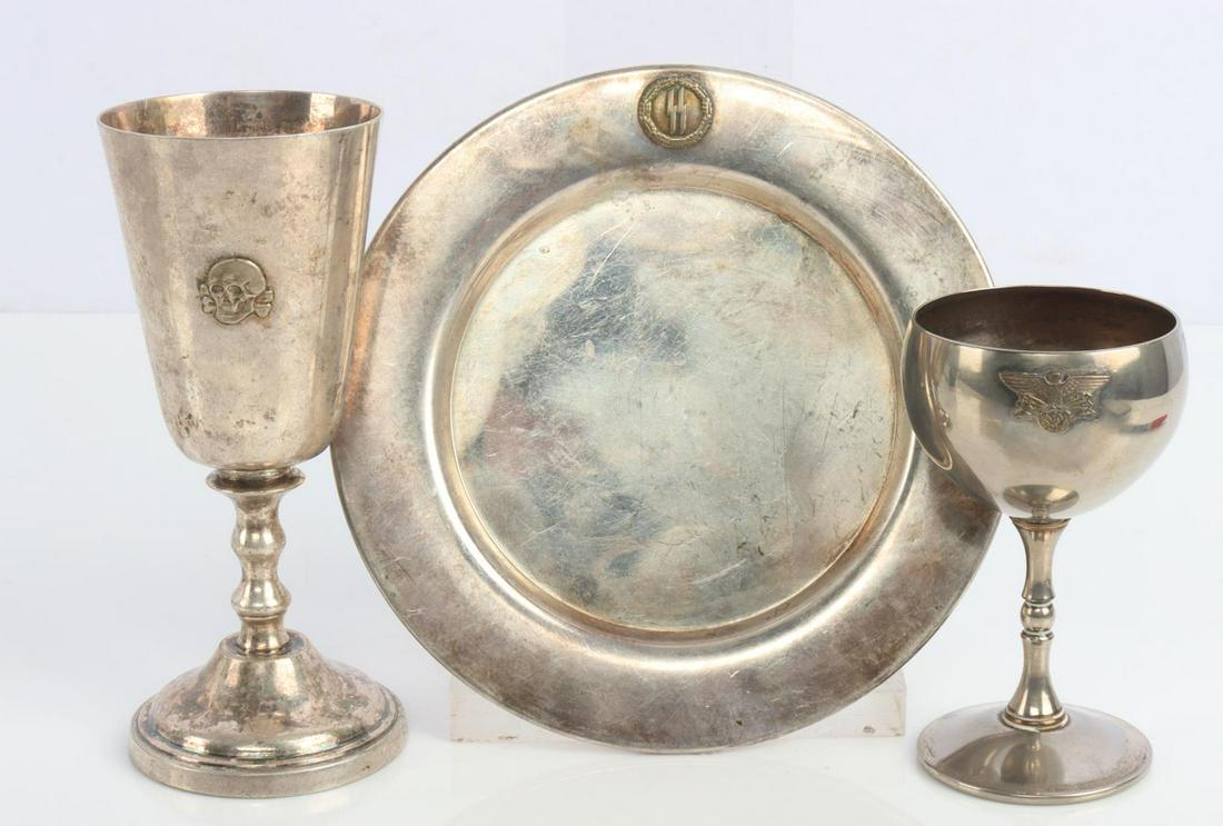 3 WWII GERMAN SS WINE GOBLET & PLATE SCHNAP'S SHOT: Lot of 3 WWII German items including: a SS Skull wine goblet, a SS plate, and a German Schnapps shot cup. Goblet is approximately 5 1/2 inches, plate is 6 inches, and Schnapps shot cup is 4 inches. Go