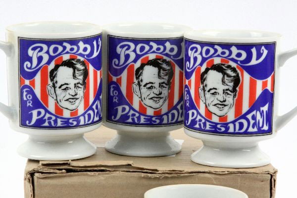 4 1968 MUGS PROMOTING ROBERT KENNEDY FOR PRESIDENT: Coffee mug promoting Robert Kennedy for president, 1968. Porcelain. Mann Made Mugs. Whimsical design features boyish likeness of RFK. Unique novelty item recalled from stores upon his death. 4 inches 
