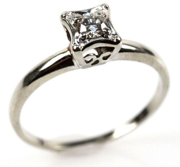 LADIES 14K GOLD DIAMOND SOLITAIRE: Ladies 14K white gold diamond solitaire ring. Features one round cut diamond totaling approx. 0.18 cts. bezel set in a cathedral mount. Size: 7.75 Weight: 2.1 g Condition: Overall in very good conditi