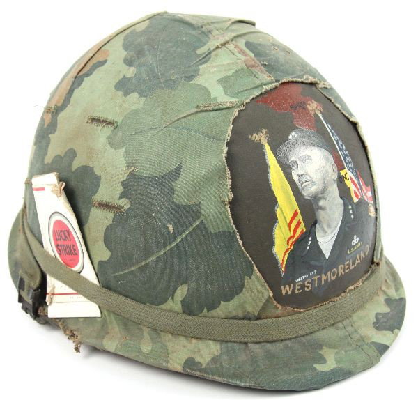 VIETNAM PAINTED WESTMORELAND M1 HELMET: Vietnam M-1 helmet with a hand painted image of Westmoreland and a empty pack of Lucky's, the helmet has a liner but it is later and a marriage.