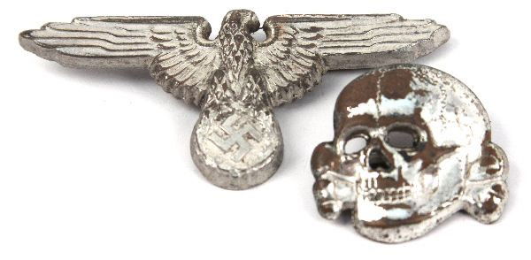 WWII SS SKULL AND CAP EAGLE: SS skull and cap eagle, some loss to finish on the skull, each is deemed authentic.