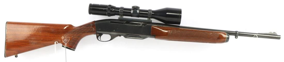 REMINGTON WOODSMASTER MODEL 742 RIFLE: Model 742 carbine rifle with Tasco scope. Clear optics with 3 - 12 X 52 zoom. Blued steel. Wooden stock. Barrel measures 19 inches. Bore has partial darkness and possibly pitting. Very good condition 