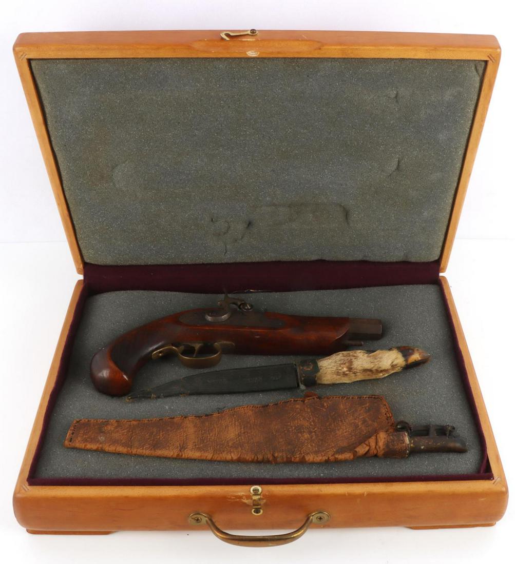 VINTAGE JUKAR SPAIN 45 CAL PERCUSSION PISTOL CASED: Vintage Jukar Spain .45 caliber percussion pistol in wooden case with dagger and black powder bag. 6 inch barrel marked left maker, caliber, and serial number. Floral designed plate. Steel shows some 