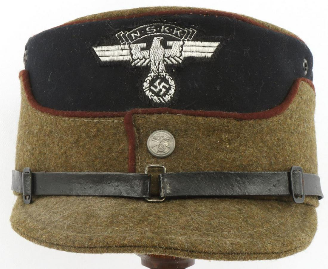 WWII GERMAN NSKK KEPI COFFEE CAN CAP RZM: WWII German NSKK Kepi coffee can cap. Green and black wool cap with NSKK eagle insignia to the front. Brown leather sweatband intact. Maker stamped and sized 58. RZM tag under sweatband numbered 128.