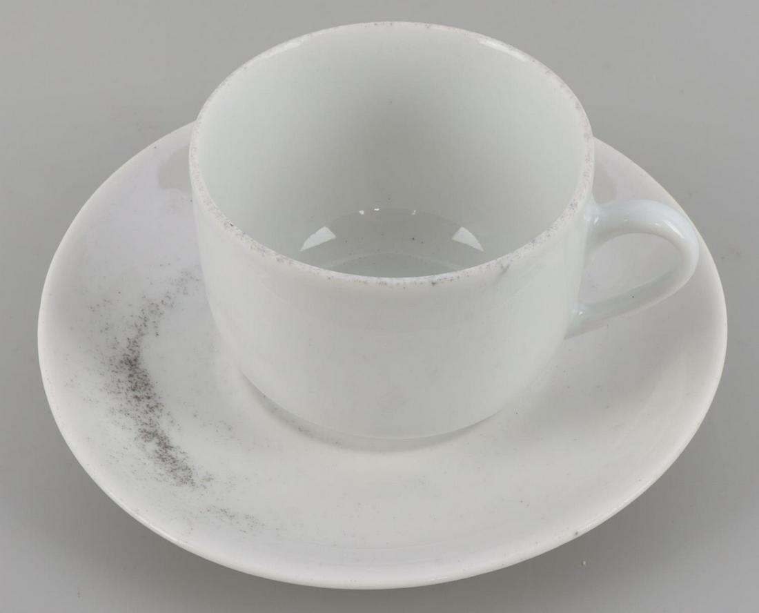 WWII GERMAN REICH SS COFFEE CUP AND SMALL SAUCER: A WWII German Reich SS coffee cup and small platter/saucer. SS-Reich Bohemia marking on bottom of both items. Cup measures approximately 3 inches and saucer 5 3/4 inches. In good condition.