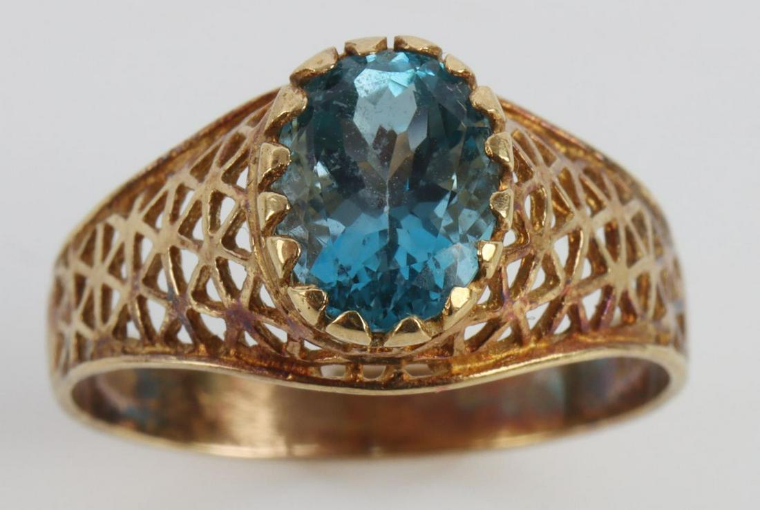 10KT GOLD FILIGREE RING W BLUE TOPAZ SOLITAIRE: 10kt yellow gold filigree ring with approximately 1.2 carat Blue Topaz solitaire. Total weight of 2.5 grams. Size 7. This lot has a reserve.