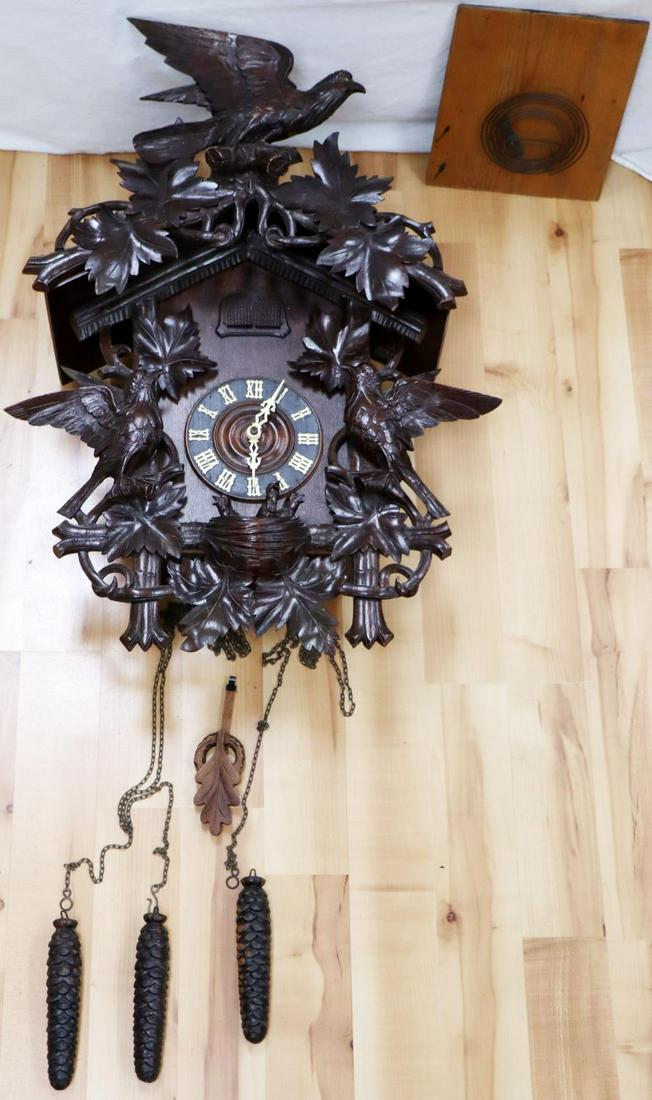 ORNATE CARVED ANTIQUE BLACK FOREST CUCKOO CLOCK: Early 20th century. Measures 30x22 inches. It is intact and has back cover. We can manually work the Cuckoo and it bellows, it appears to be in working condition but we did not test it. Seller states