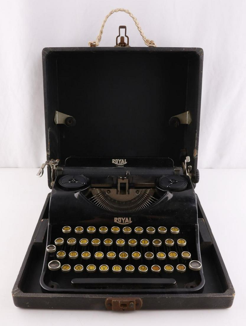 VINTAGE ROYAL JUNIOR TYPEWRITER IN CASE: Vintage Royal Junior typewriter in case. Royal typer writer in fully functioning condition. Some letters have residue from age causing them to stick. Overall good condition. Black wooden case closes t