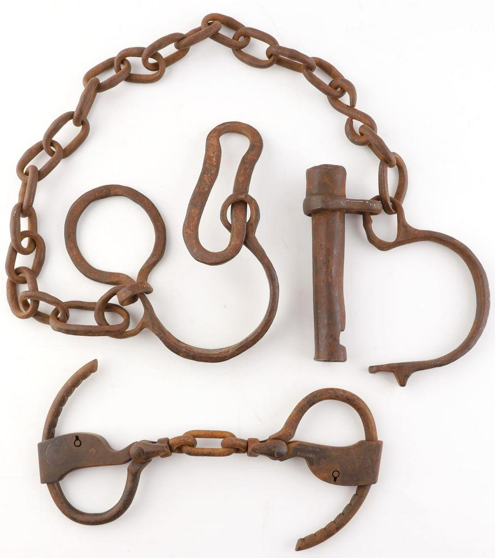 2 TOWER'S DOUBLE LOCK HANDCUFFS & FORGED LEG IRONS: Lot of 2 items including a Tower's double lock handcuffs, no key, and hand forged leg irons. Handcuffs have Tower's makers mark, but there is no visible marking on leg irons. Handcuffs measures approx